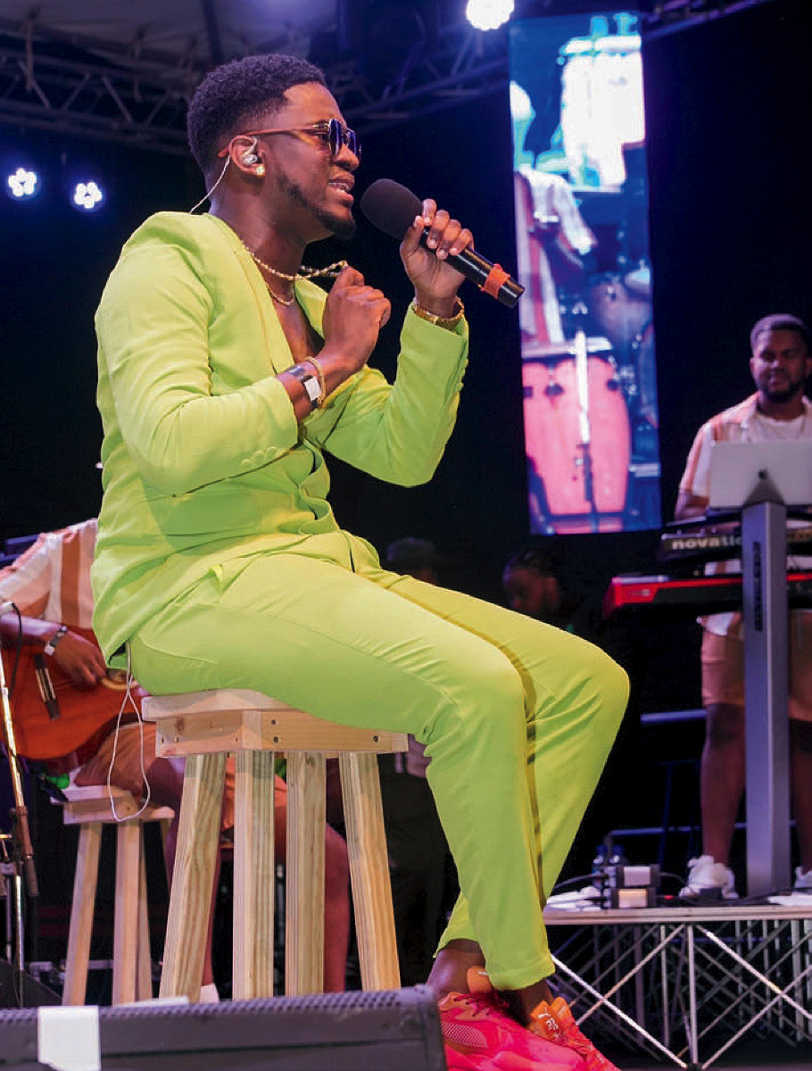 A photo of Shelly on stage singing in a lime green suit