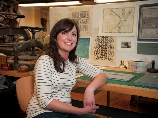 Hulsey in her studio, with letterpress machines behind her