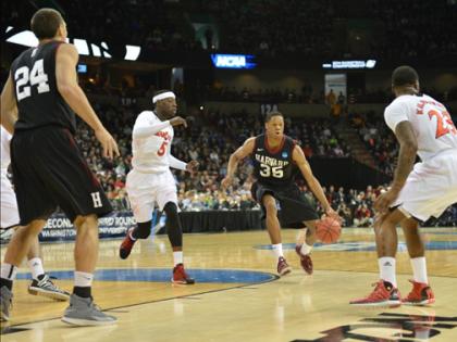 In the NCAA basketball tourney, Agunwa Okolie handles the ball for Harvard. The Crimson will face Michigan State on March 22.