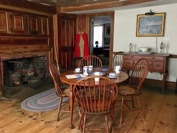 Kitchen at Whittier Birthplace with round wood table and 4 chairs and wood surround fireplace