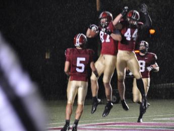 Levitation on a rainy night: Harvard receivers celebrated after a 35-yard touchdown pass to tight end Cameron Brate (87) in the opening period of the Crimson’s 52-3 rout of Holy Cross. Quarterback Colton Chapple threw two scoring passes to Brate and one each to Ricky Zorn (5) and Kyle Juszczyk (44) in a 49-point first half.