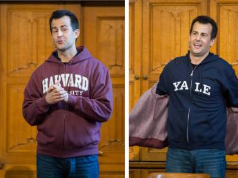 Photo of David Malan taking off his Harvard sweatshirt to reveal a Yale one