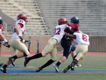 Linebacker Jacob Lindsey (51) trails the play as safety Reynaldo Kirton (22) and cornerback Brian Owusu (6) bring down Penn quarterback Billy Ragone. Ragone rushed for 95 yards and a touchdown, passing for two more Quaker scores in a 30-21 upset.