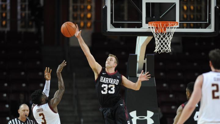 Captain Evan Cummins '16 (also shown in action against BC) blocked three Dartmouth shots and scored 10 points in the win over the Big Green.