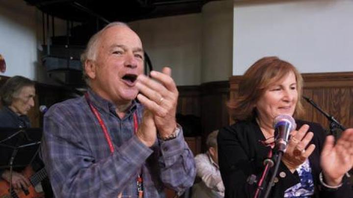 Chris Mortenson and his wife, Winnie, applaud an open-mic music session