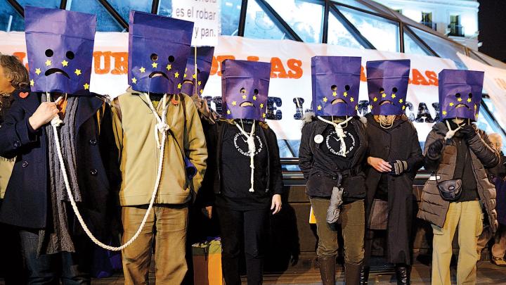 Political passions: Madrid protesters against austerity wear nooses and bag their heads with a European Union flag motif, March 16, 2013. 
