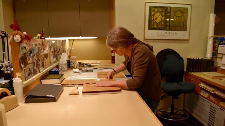 A book conservation specialist works on the preservation of rare books in Widener’s Conservation Lab, located in its basement.