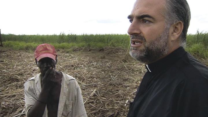 Father Christopher Hartley with a Haitian plantation worker