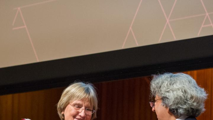 GSD dean Mohsen Mostafavi awards President Drew Faust an honorary certificate naming her a “grounded visionary” during Friday’s opening event in Sanders Theatre.