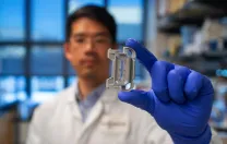 A scientist holds up an experiment item