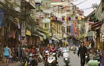 Hanoi&rsquo;s streets (in 2007, above) are now full of motorcycles and scooters, and shop shelves are no longer bare.
