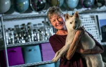 Linnea Olson, shown with her dog, Kumo, has survived 13 years with lung cancer.