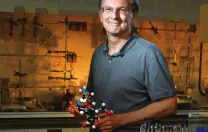 Jack Szostak, in his lab at Massachusetts General Hospital, holds a model of a nucleic acid.