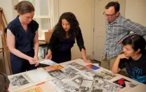 Hinton arranges materials for the Angela Davis exhibit with (from left) Radcliffe arts program manager Meg Rotzel, gallery coordinator Joe Zane, and Pforzheimer fellow Jackie Wang.