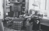 A 1940s undergraduate listens to records in his suite. 