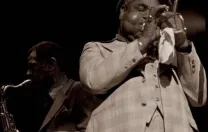 Photograph of jazz greats Dizzy Gillespie on trumpet and Dexter Gordon on tenor saxophone, circa 1976