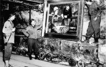 At the Merkers salt mines in central Germany, American GIs admire Édouard Manet’s <em>In the Conservatory,</em> one of the thousands of rare works and documents stored there by the Nazi regime late in World War II. Monuments Man George Stout (see next image), a Fogg Museum conservator turned U.S. Army lieutenant, supervised the rescue of 40 tons of art from the site in April 1945.