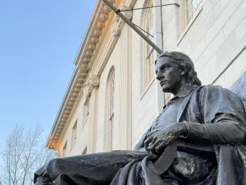 John Harvard statue at University Hall
