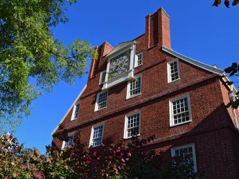 Gold clock on the top of Massachusetts Hall 