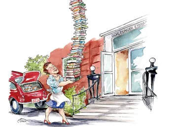 A woman struggles to carry a tall stack of books while approaching a building.