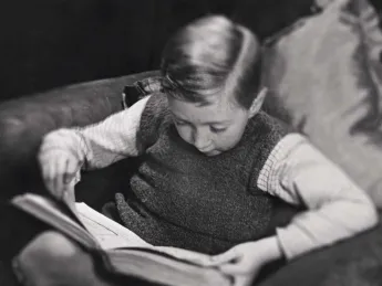 Photo of a young boy reading a book