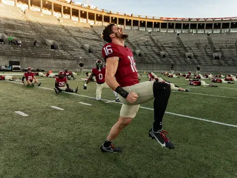 Harvard football players limbering up for season-opening game