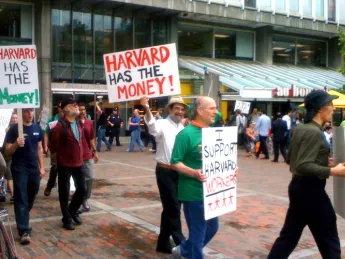 Students and workers protested layoffs on June 25, in a march that began in Harvard Yard and proceeded to Holyoke Center.