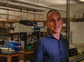 David Reich standing in his Harvard Medical School laboratory
