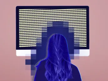 Woman sitting in front of a screen with a blue glow