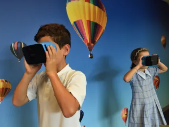 Boy and girl uses VR goggles