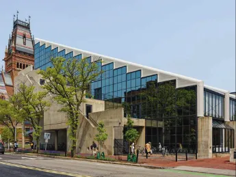 Photograph of the back side of Gund Hall and Memorial Church in the background