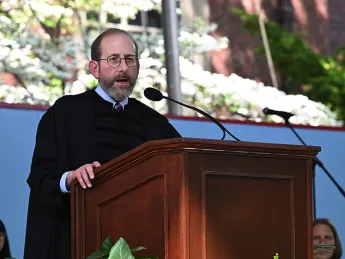 Alan Garber stands at podium under tent