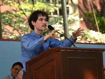 Man at podium addressing audience