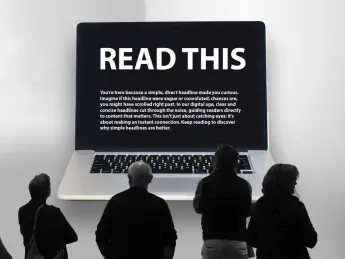 Five people, viewed from behind, are standing in front of a large, wall-mounted laptop screen displaying the text 'READ THIS' in a large, white font on a black background. 