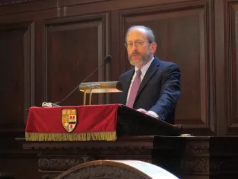 Harvard President Alan Garber at a podium in Memorial Church