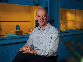 Professor David Mooney in his lab with lab hoods behind him