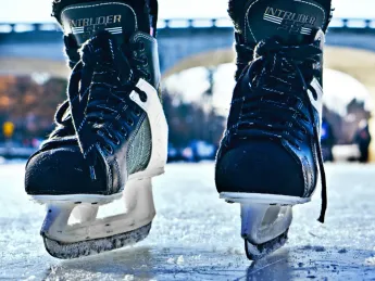 A photograph of ice hockey skates seen from the ice