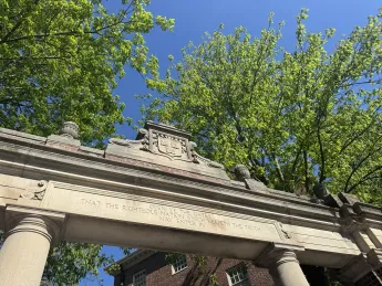 Harvard gates with inscription that reads "Open Ye the Gates That the Righteous Nation Which Keepeth the Truth May Enter In"