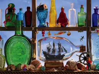a shelf filled with bottles and glass bottles