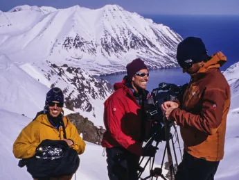 group of people with camera equipment above the fjords in Iceland 