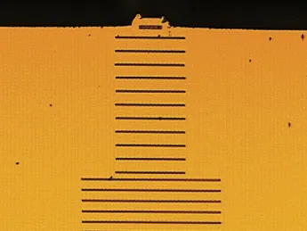 Wavelength scale grating (above) on the facet of a tiny semiconductor laser (below) creates multiple laser beams parallel to the original.