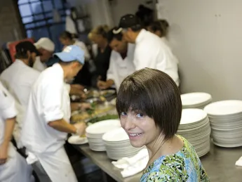 Too many cooks  in the kitchen? Not for LaRochelle and her staff, who are preparing citrus-marinated grilled mojo chicken with apple-raisin chutney for a wedding banquet. 