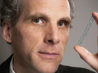 David Jones holds a vascular stent (from the Warren Anatomical Museum), designed circa 1995 by radiologist Morris Simon of Harvard Medical School.