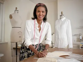 Designer Katiti Kirondé with her white shirts at the Fashion Lab of Fisher College in Boston