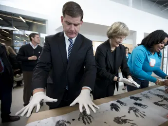 Harvard University president Drew Faust and Boston mayor Martin J. Walsh participate in a community art project at the opening of the Ed Portal’s new building in Allston.