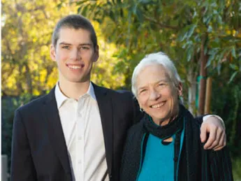 A grandson with his arm around his grandmother