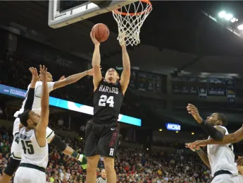 Harvard's Jonah Travis goes up for a layup.