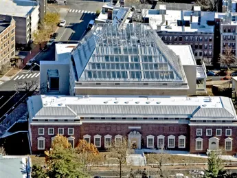 The façade of the new 204,000-square-foot Renzo Piano-designed facility rises from the back of 32 Quincy Street.