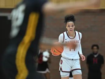 Harmoni Turner '25 brings the basketball up the court.