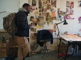Craig and Krimes talk in an art studio